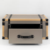 Milo storage box with front drawer open, containing jewelry and watches on a mid-century modern vanity.